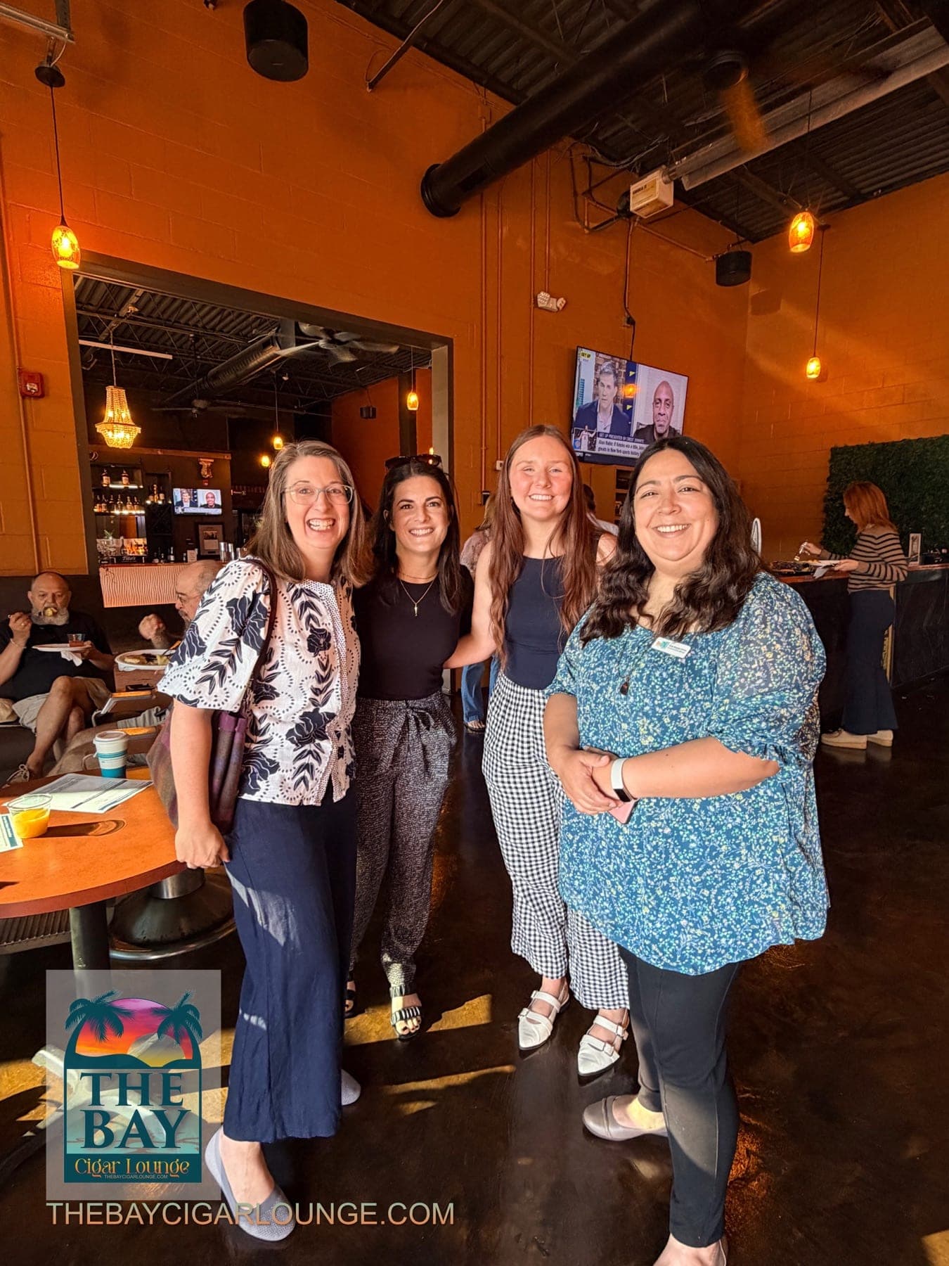 Four event attendees standing together inside The Bay