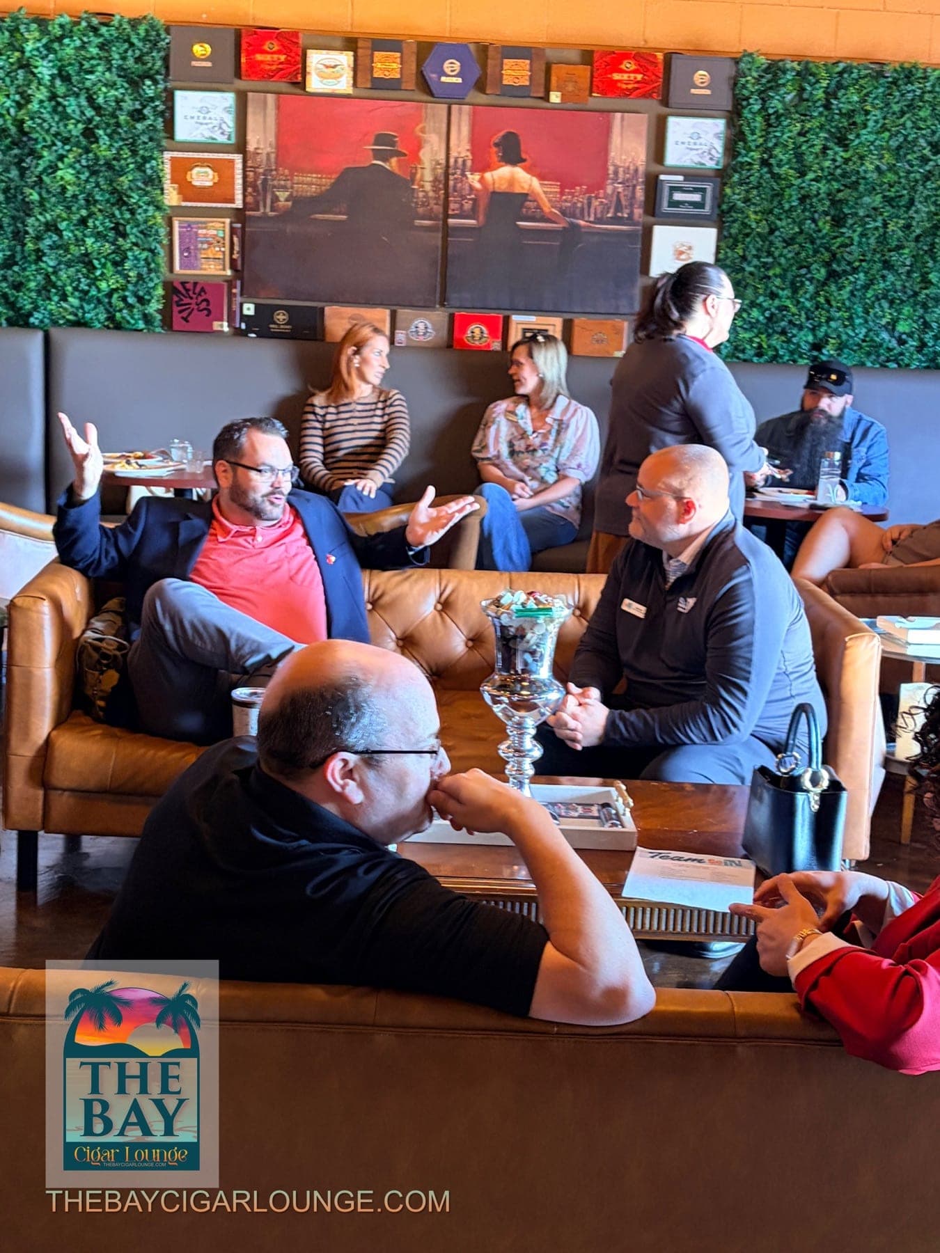 Guests sharing conversation across the lounge seating area