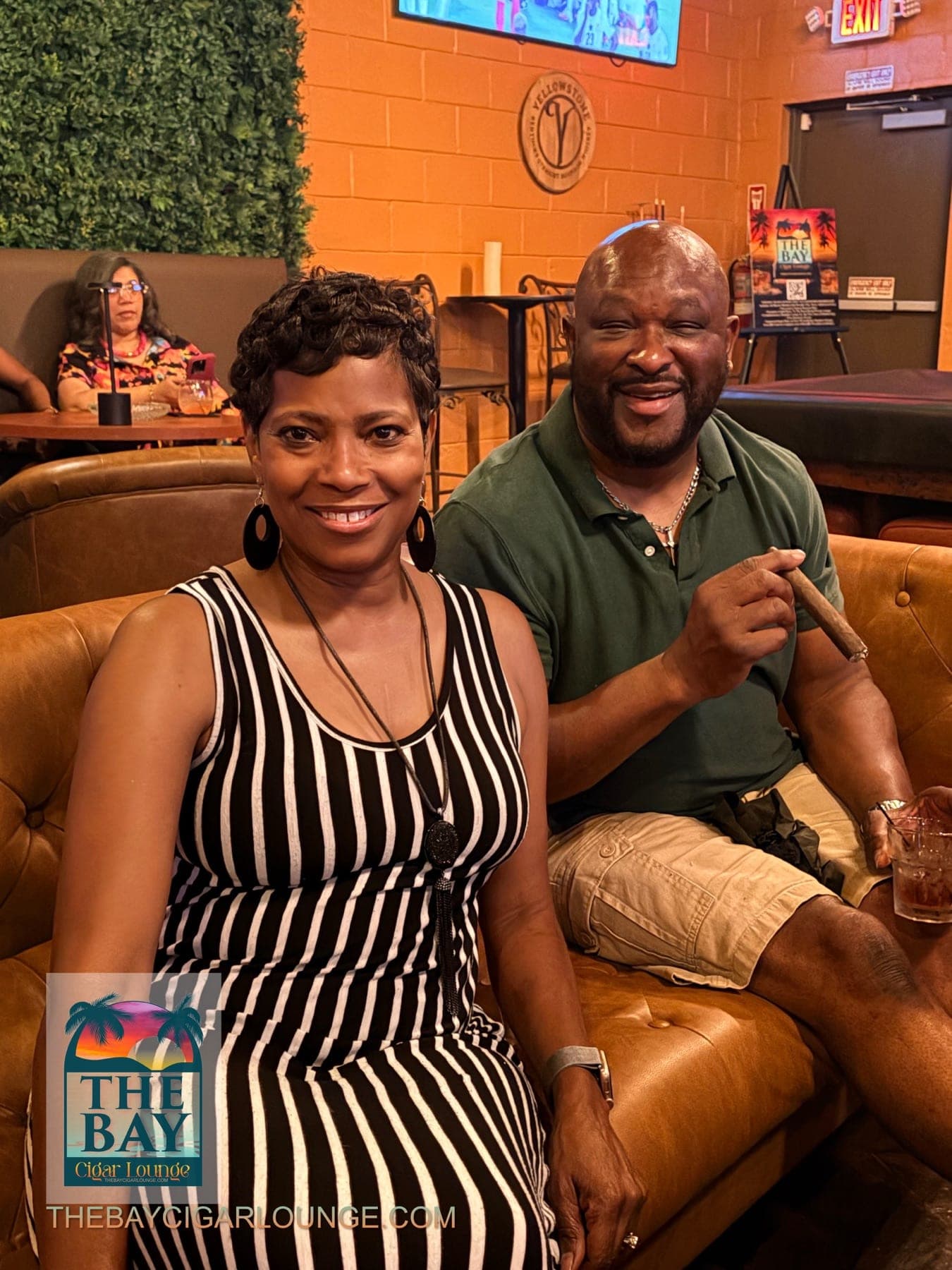 Two guests seated together with a cigar in the lounge